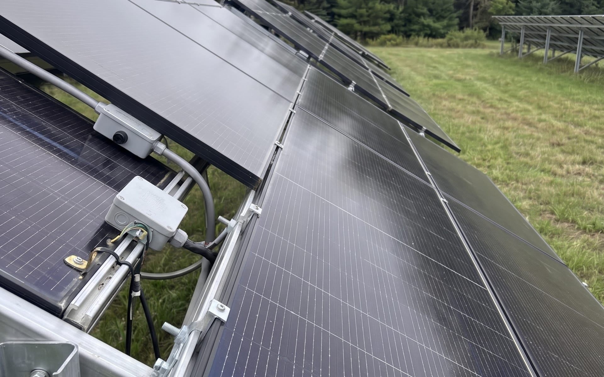 The same ground-mount array from the same angle after a pure-water cleaning