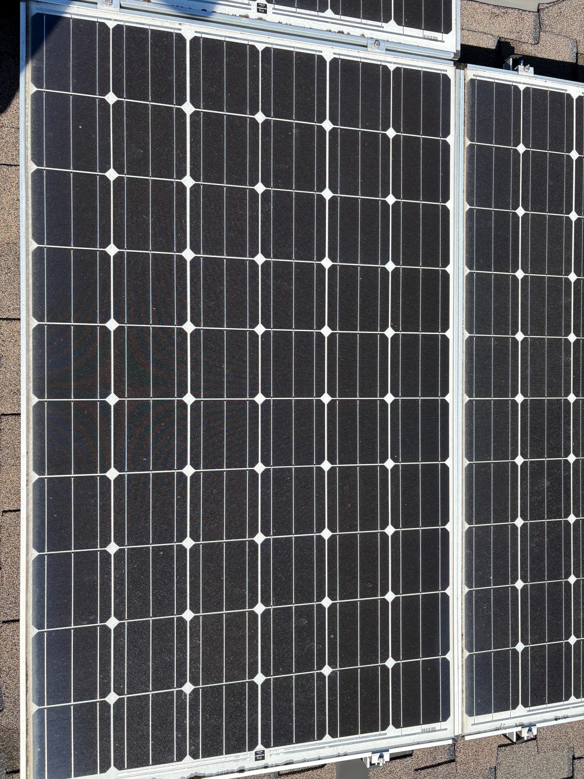 A top-down close-up of clean solar panel glass and cells